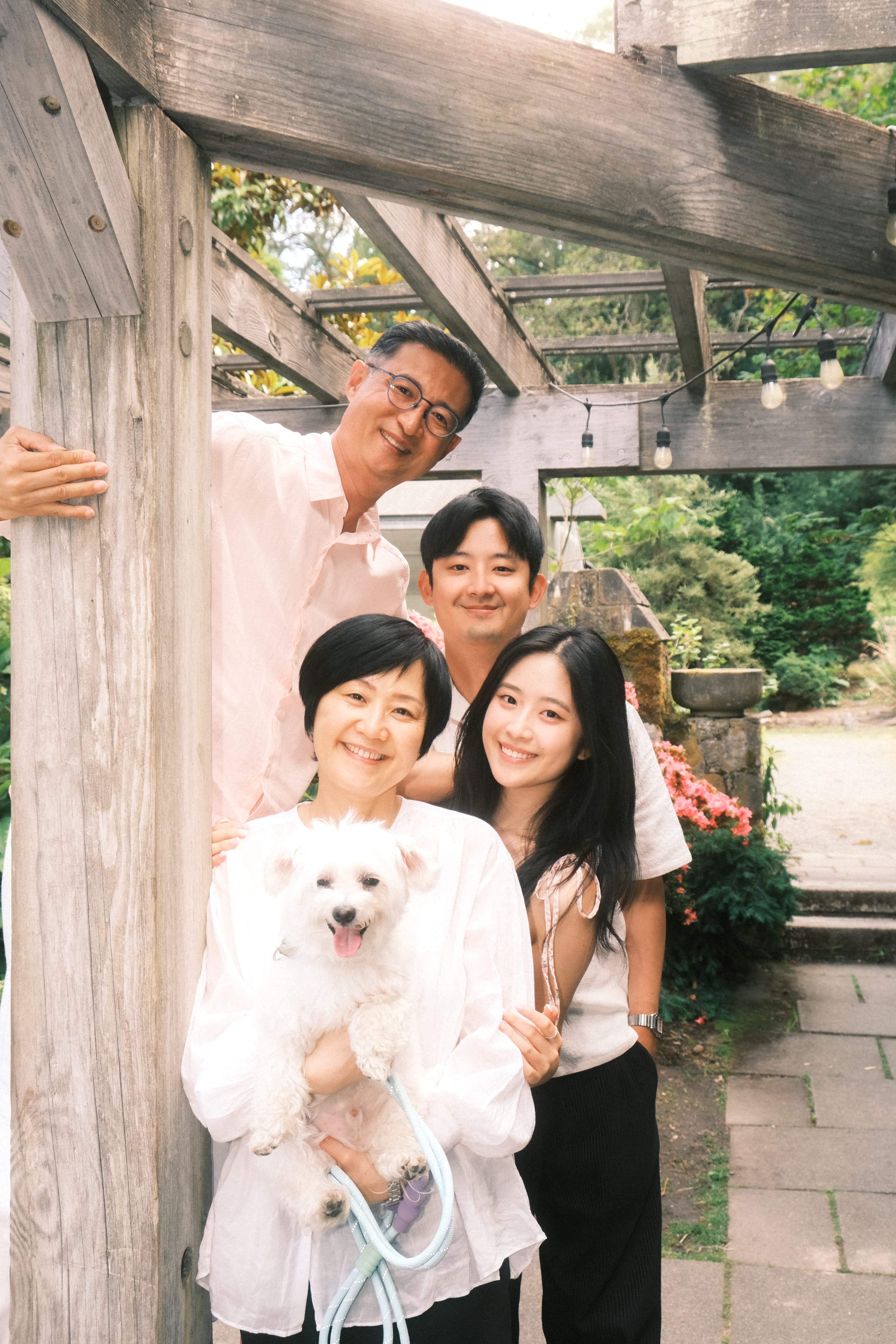 Family portrait under a wooden pergola